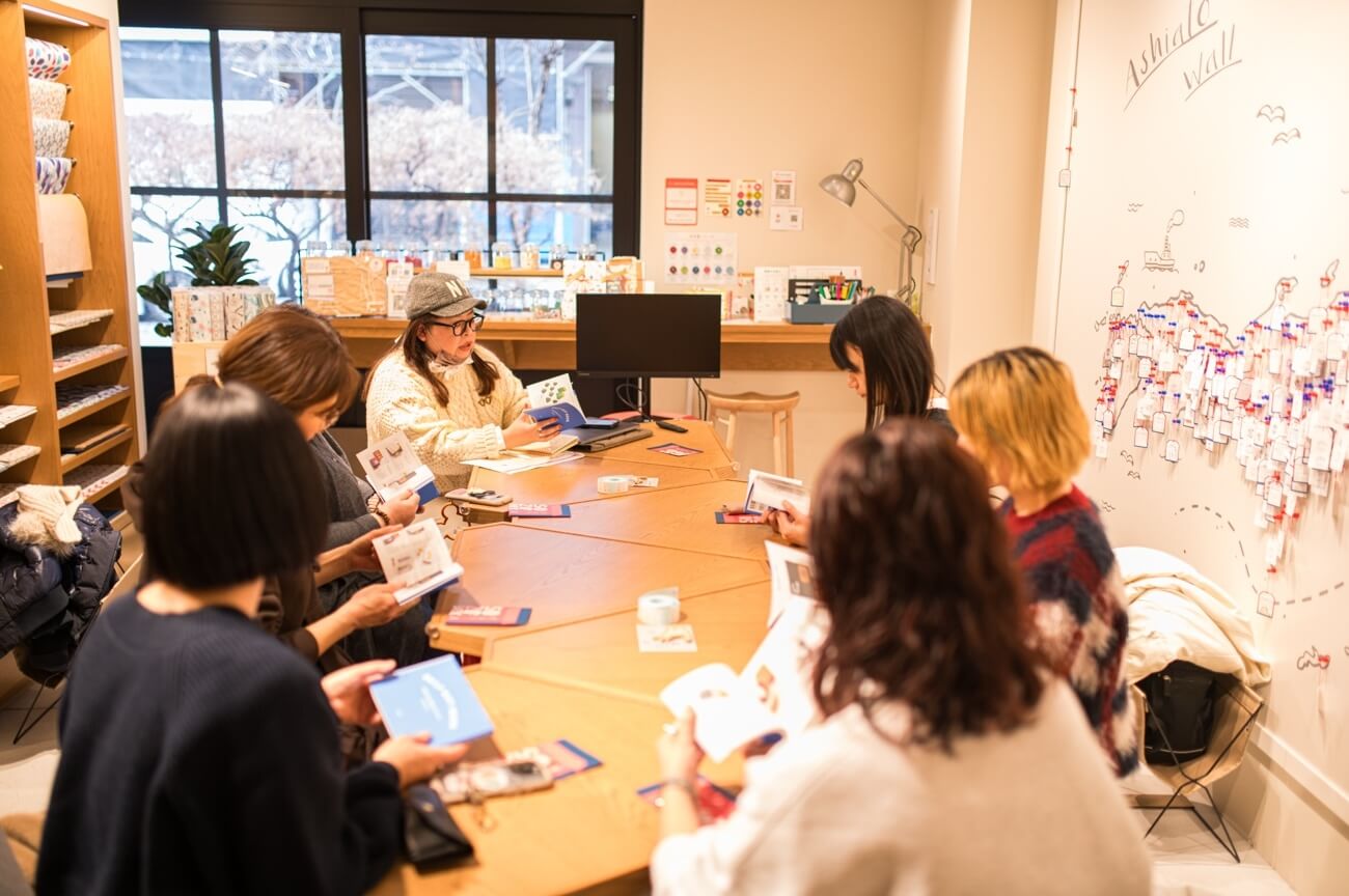 写真:イベントにて参加者がテーブルを囲み作業を行う様子